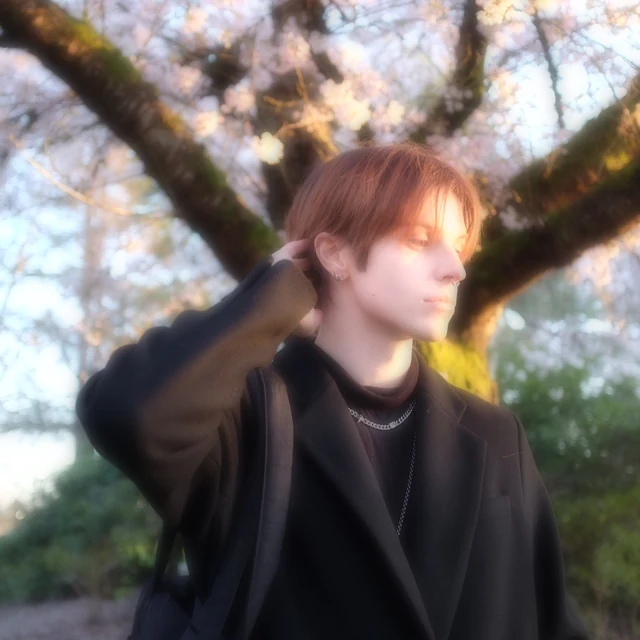 Philippe Patient beneath flowering trees